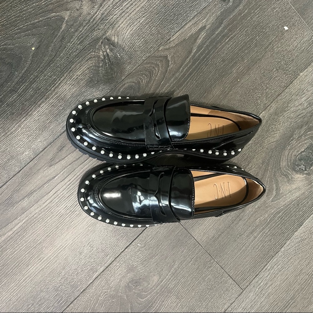 Black loafers with pearl detailing